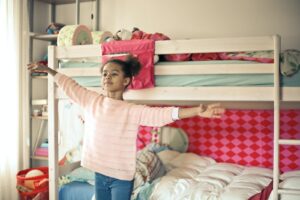 happy free child standing in bedroom